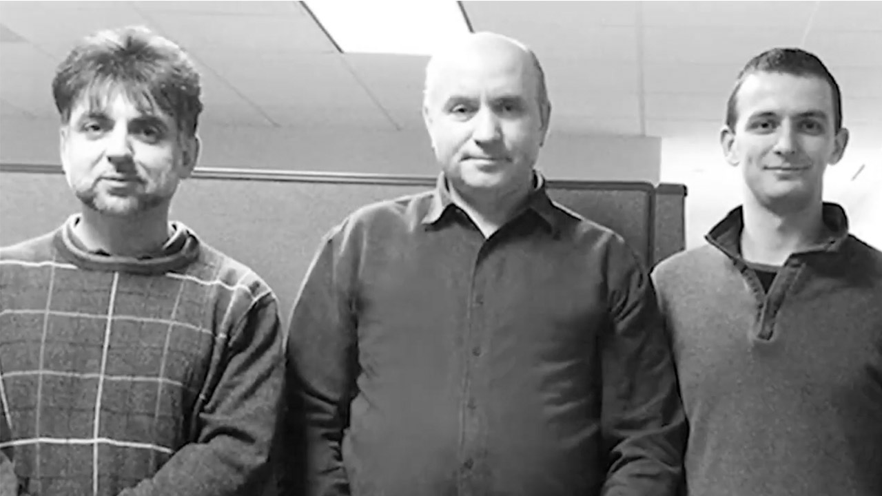 Black and white pick of Mark and other PCMI employees in office